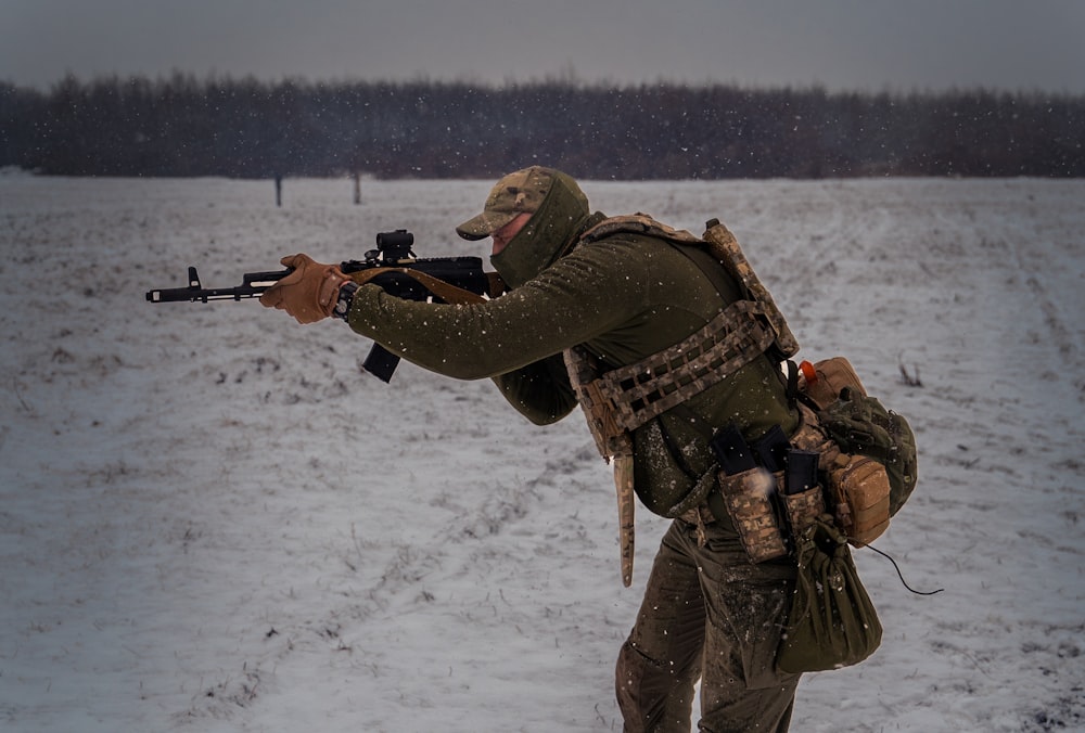 a man with a rifle in the snow