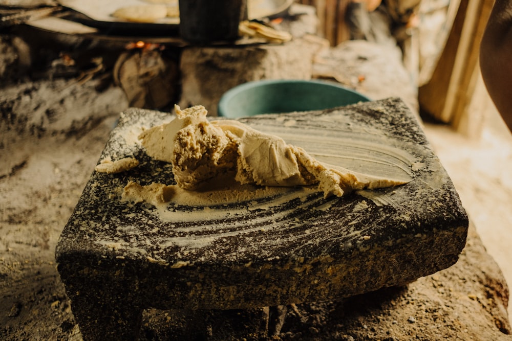 a piece of cake sitting on top of a stone slab