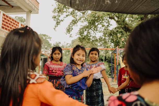 a group of young girls standing next to each other