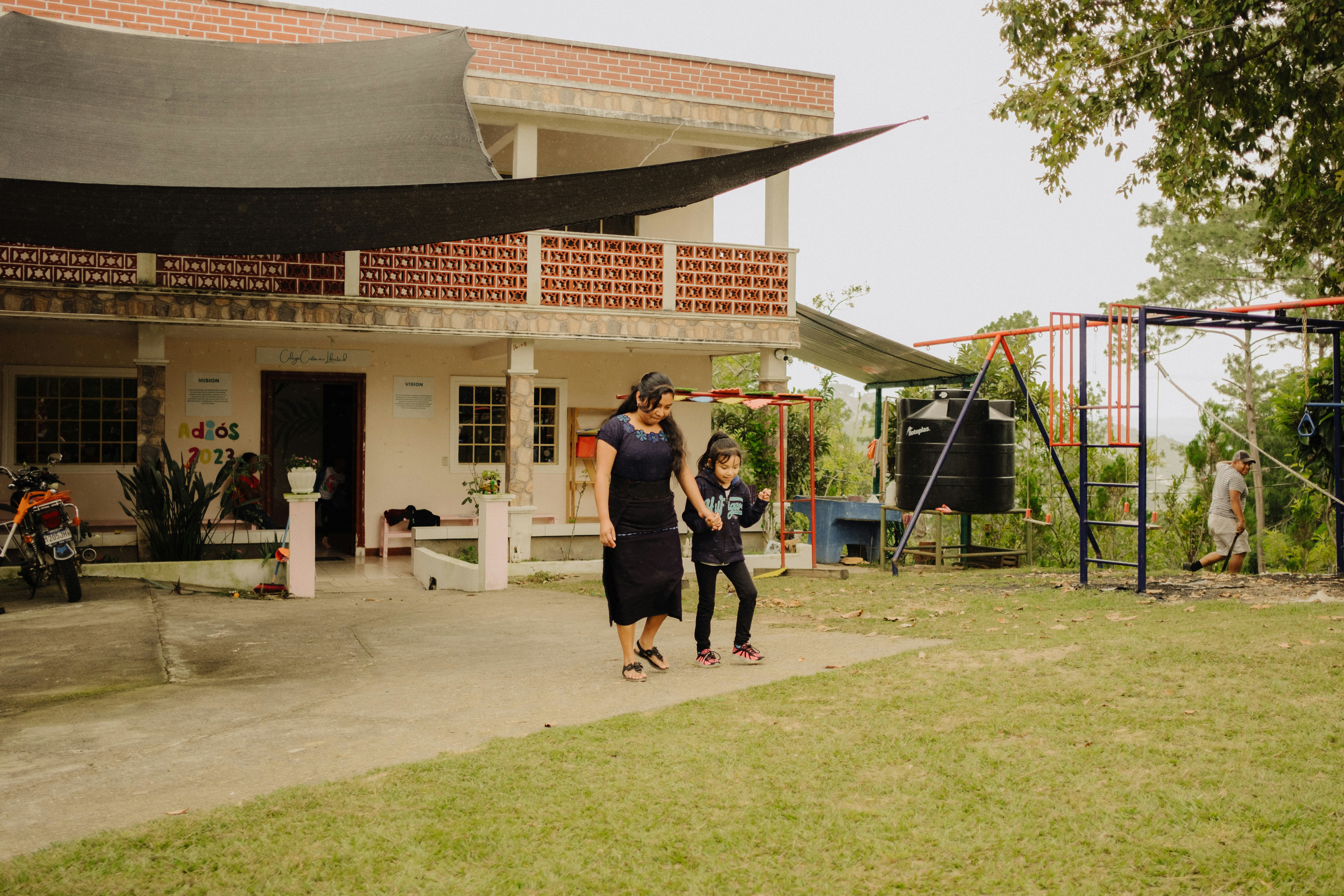 a couple of people that are standing in the grass