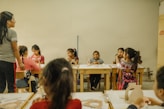 a group of children sitting at desks in a classroom