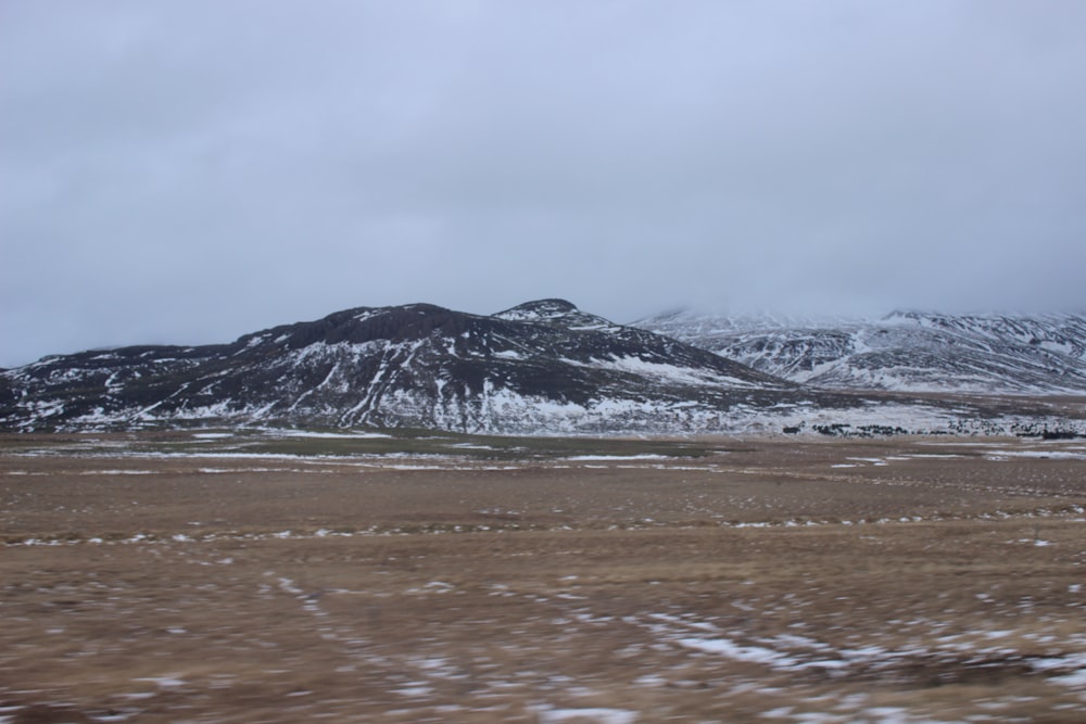 a snow covered mountain range in the distance