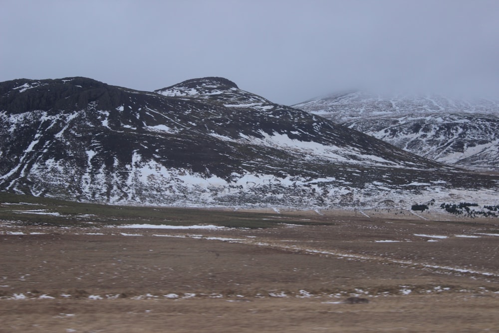 a snow covered mountain range in the distance