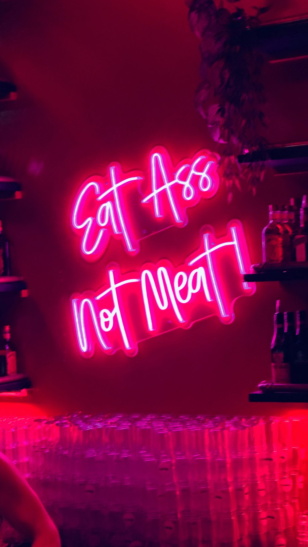 a neon sign that says stay at home