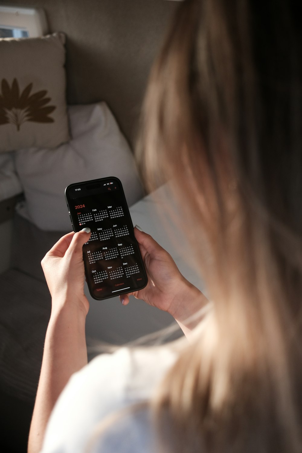 a woman holding a cell phone in her hands