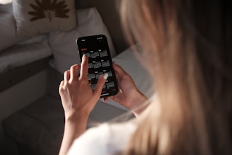 a woman holding a cell phone up to her face