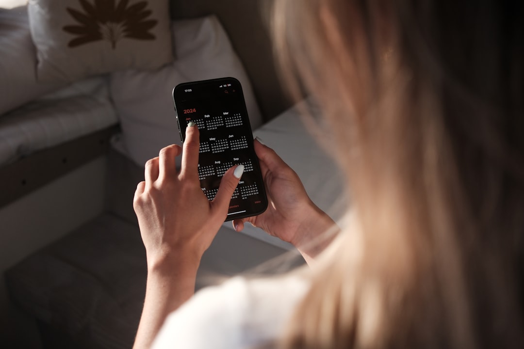 a woman holding a cell phone up to her face, Planing 2024