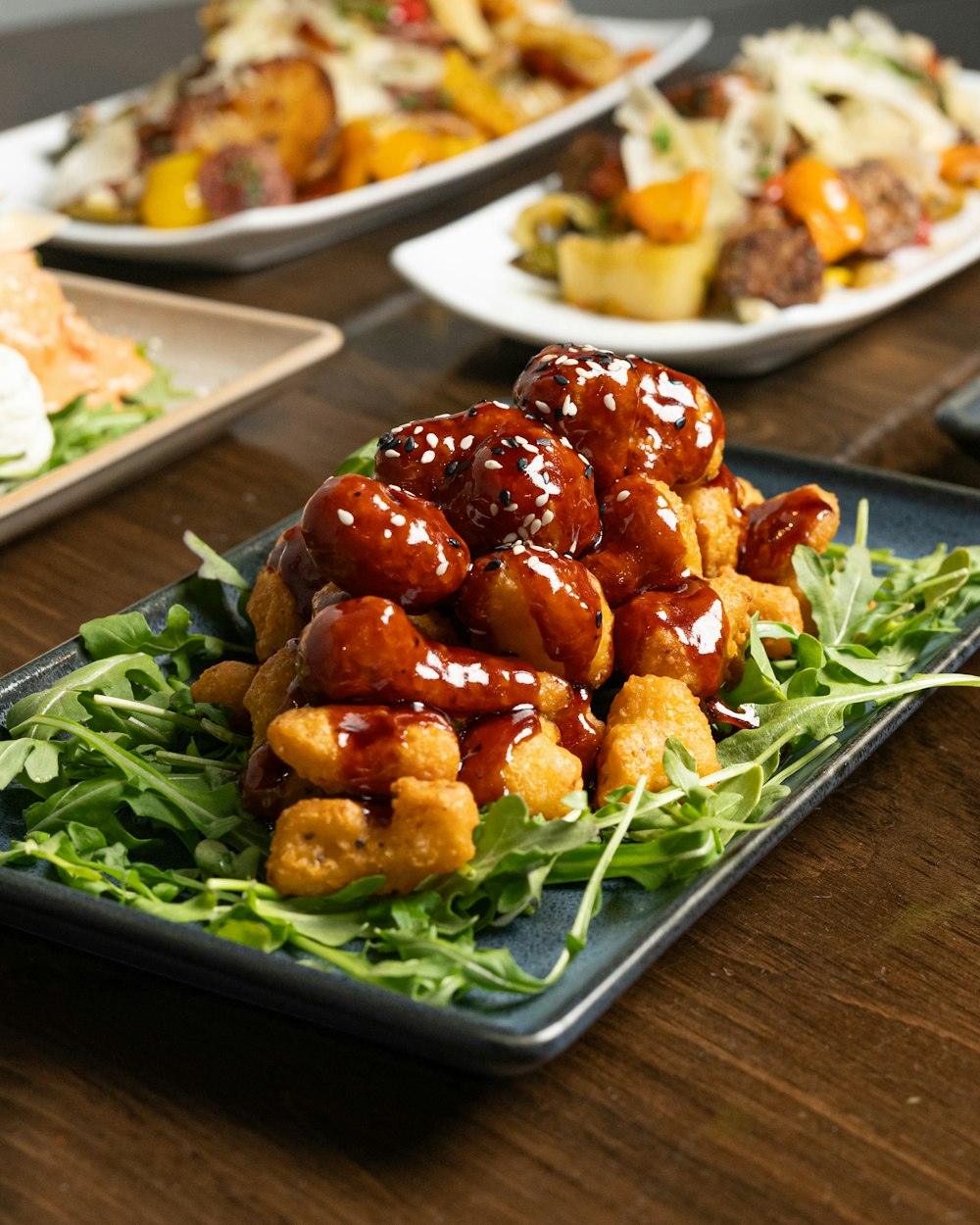 a table topped with plates of food covered in sauce