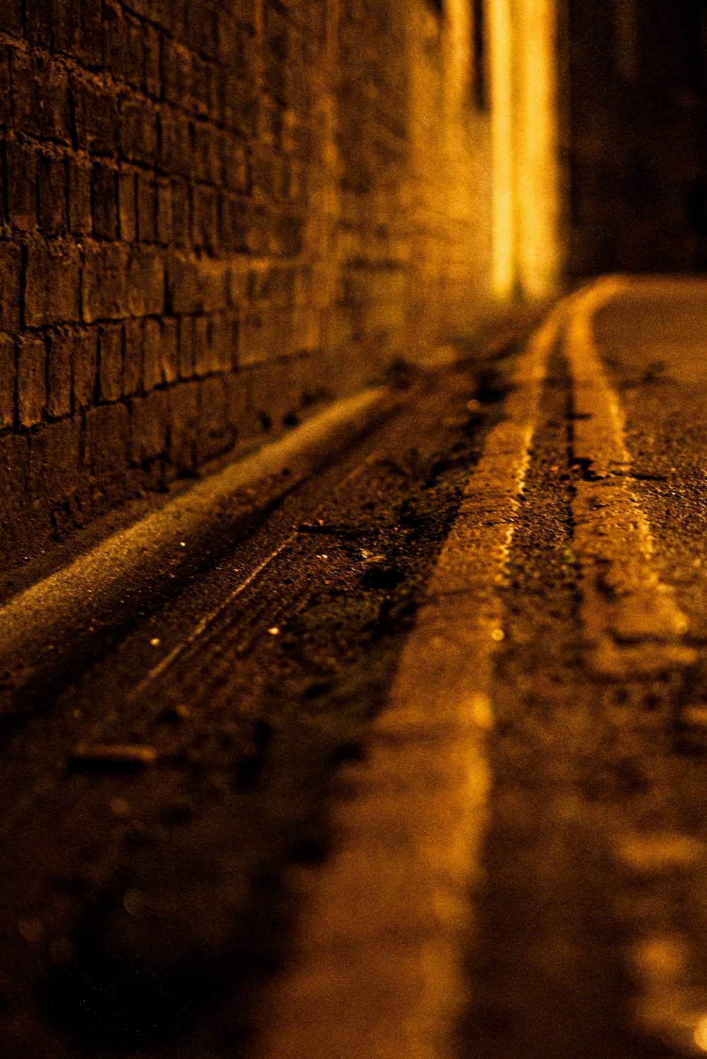 a street with a brick wall and a street light