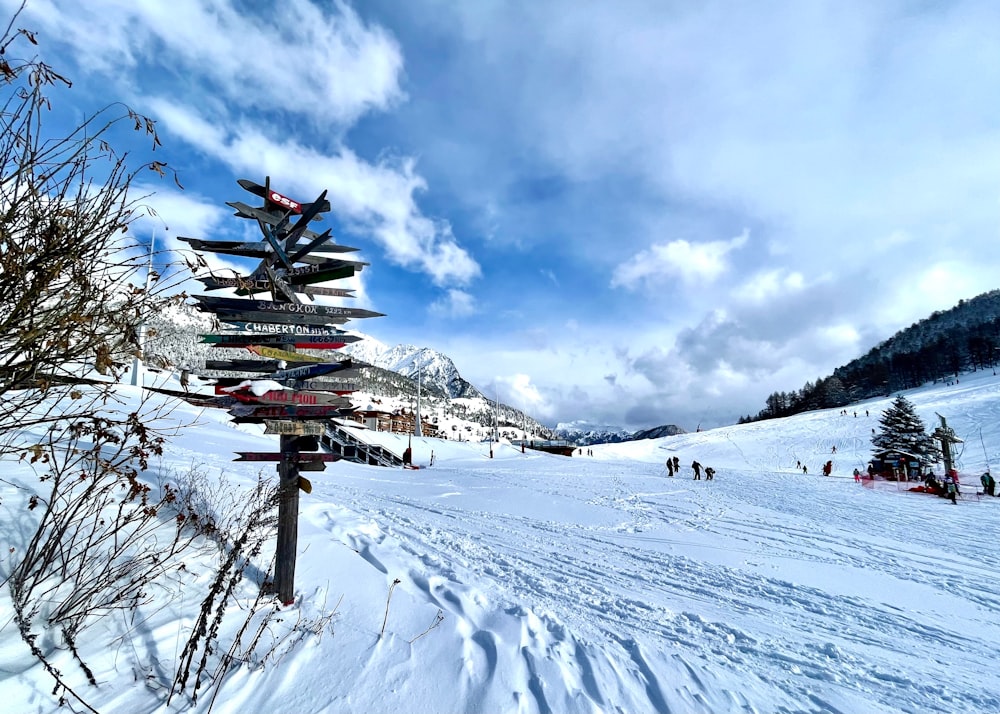 a sign post in the middle of a snow covered field