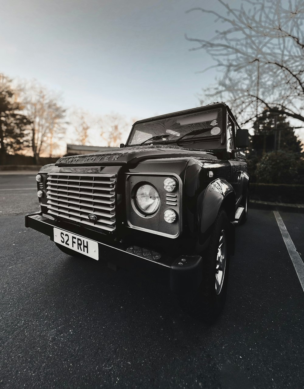 a black land rover parked in a parking lot