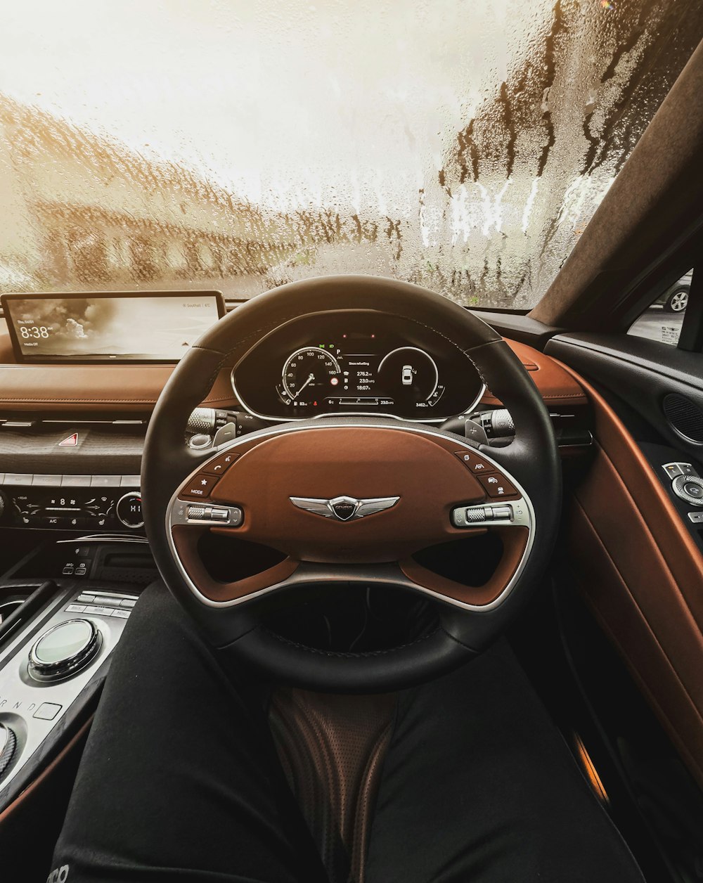 a car dashboard with a steering wheel and dashboard lights