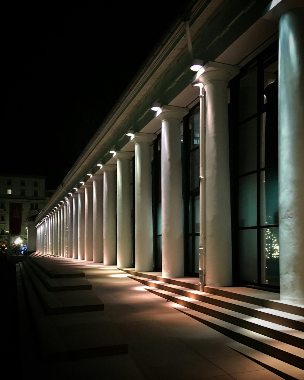 a row of white pillars sitting next to a building