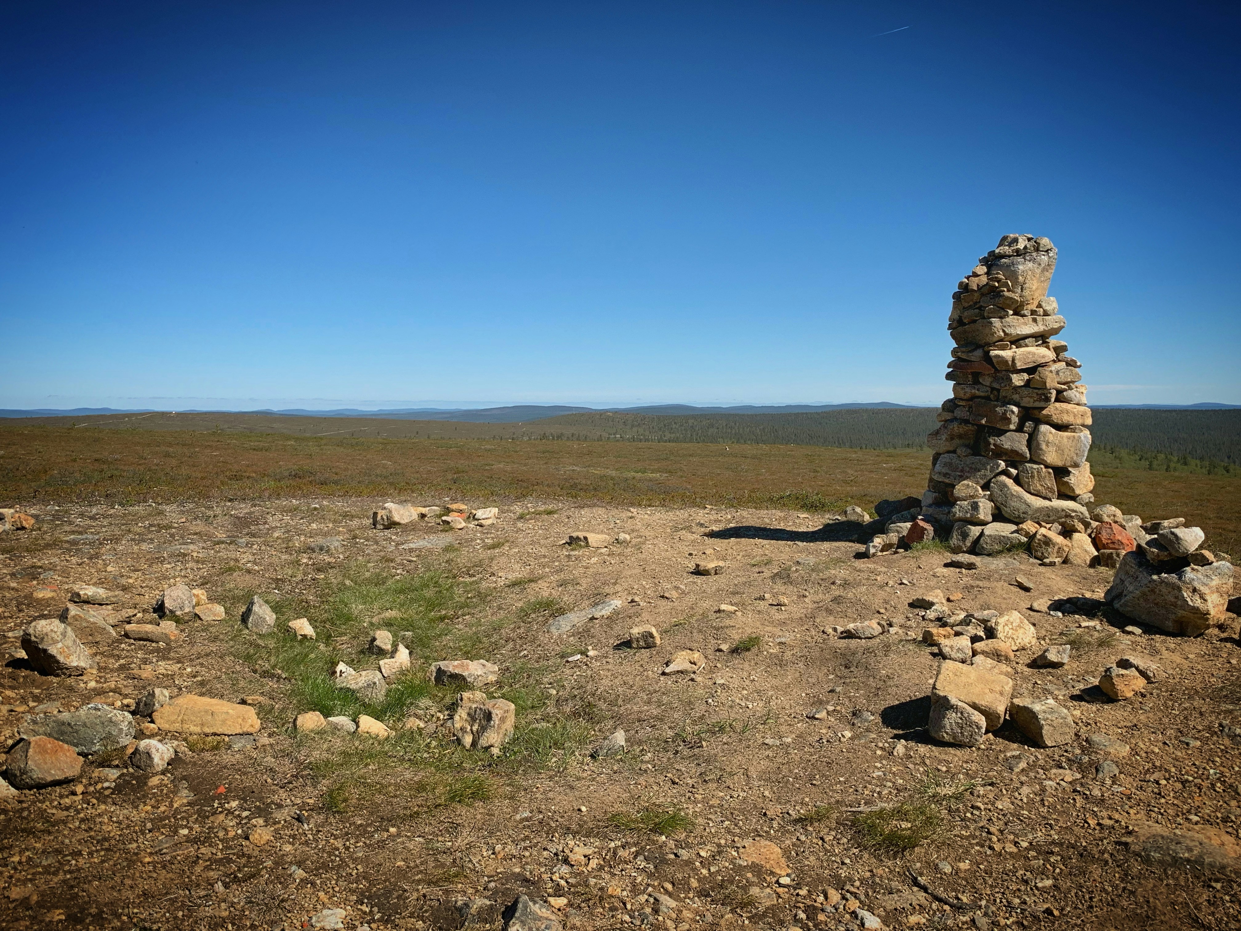 a pile of rocks sitting on top of a dry grass field