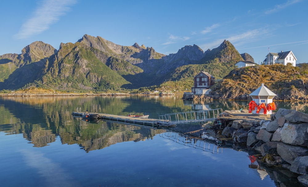 a lake with mountains in the background and a dock in the foreground