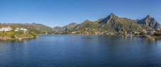 a body of water with mountains in the background