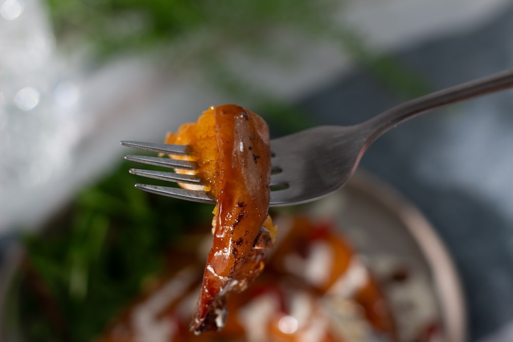 a fork with a piece of food on it