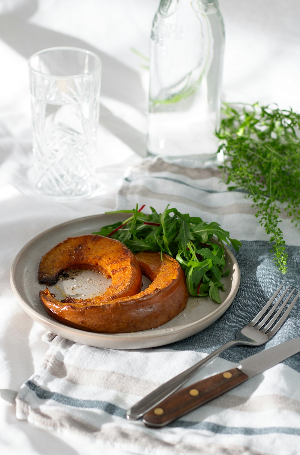 a plate of food on a table with a fork and knife