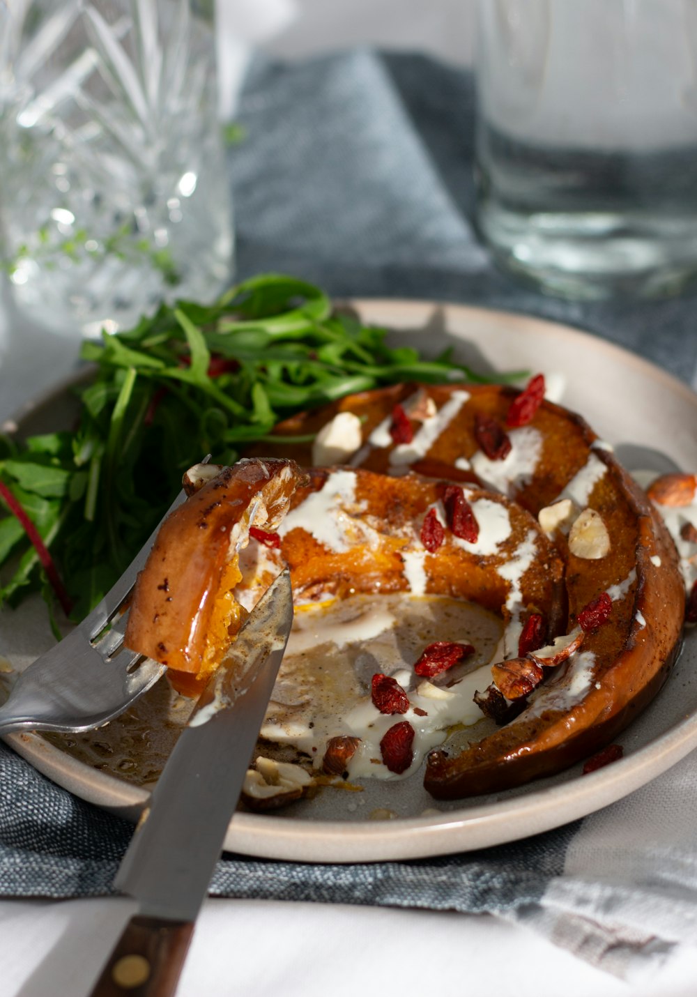 a plate of food on a table with a knife and fork