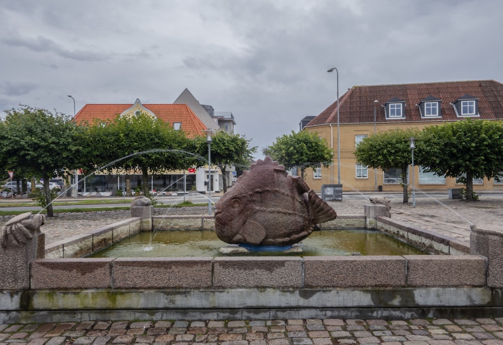 a large rock sitting in the middle of a fountain