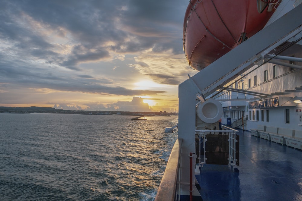 the sun is setting over the ocean on a cruise ship