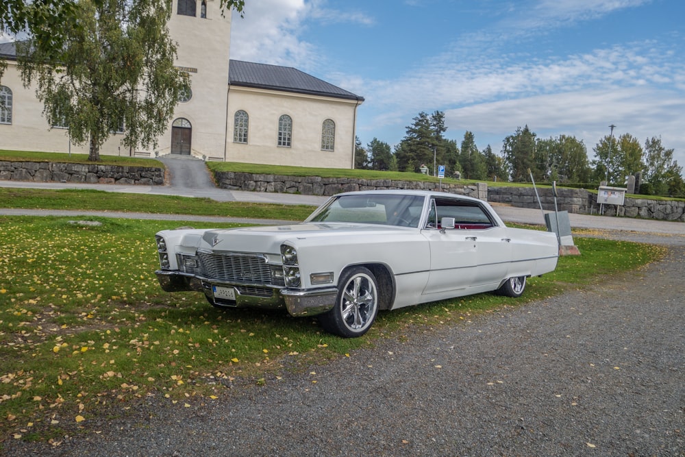 a white car parked in front of a church