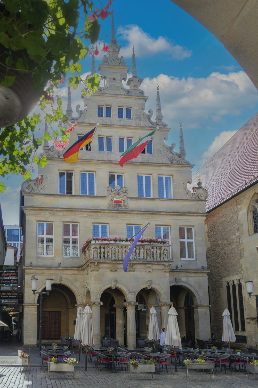 a large building with flags flying in the wind