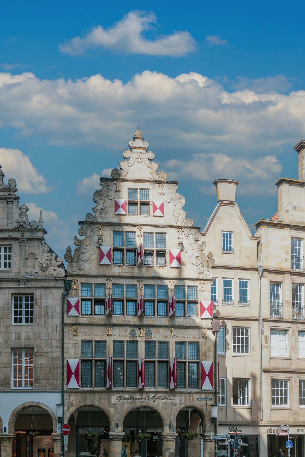 a row of buildings with a clock tower in the middle