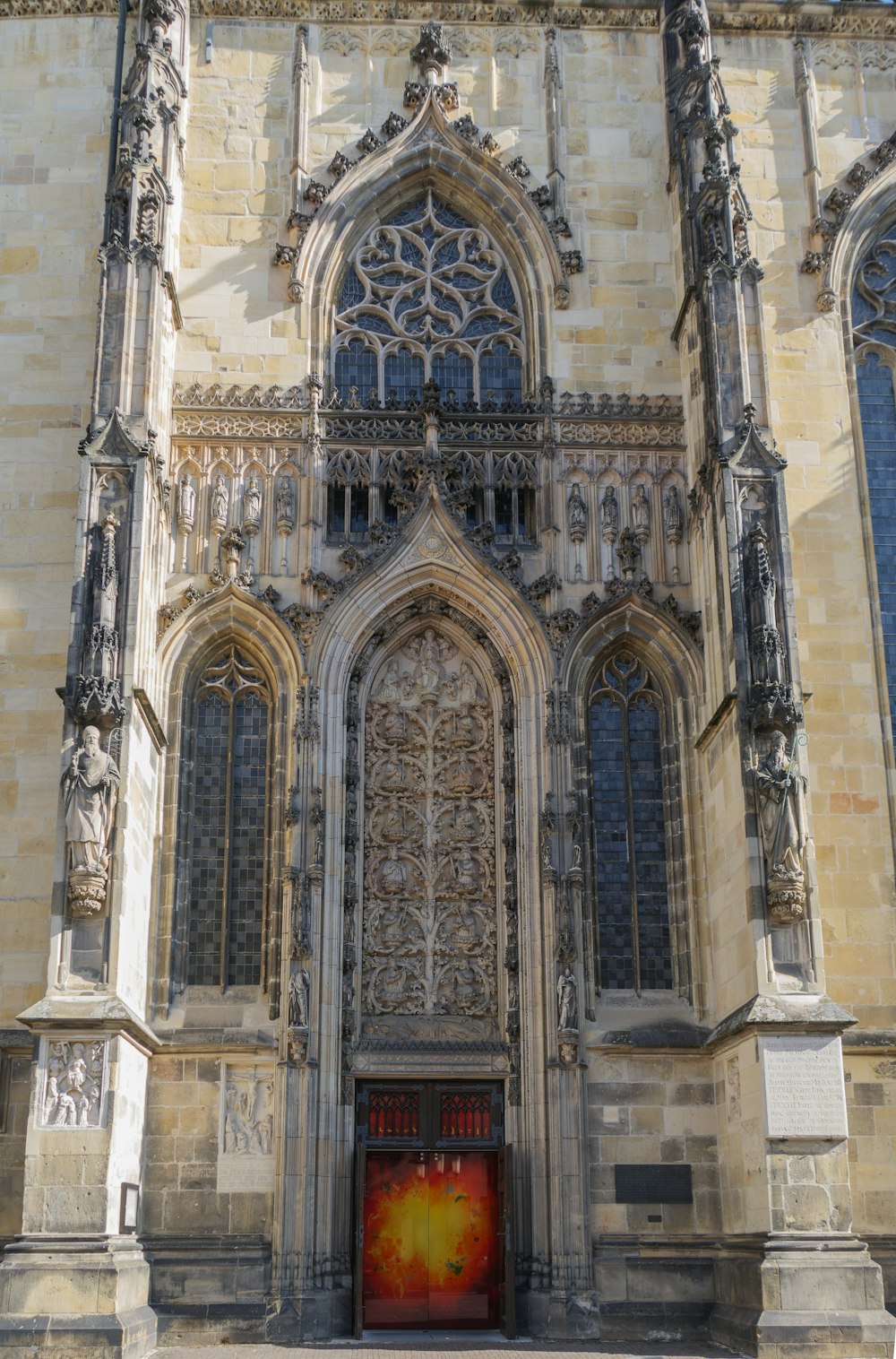 a large stone building with a red door