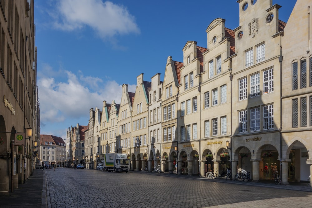 a row of buildings on a cobblestone street