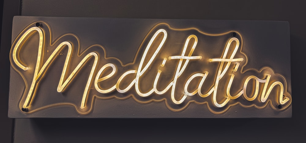 a neon sign that says meditation on it