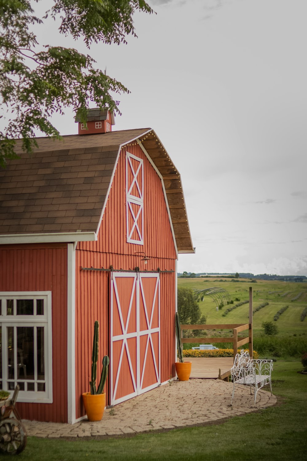 a red barn with a red door and a white bench