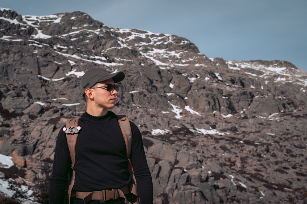 a man standing in front of a mountain