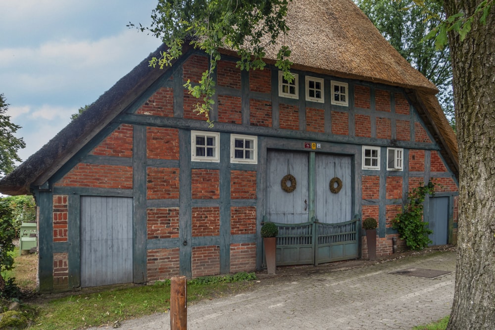 an old brick building with a thatched roof