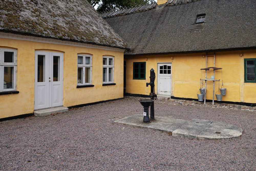 a yellow building with a parking meter in front of it