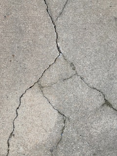the crack in the concrete showing the damage ice buildup can cause