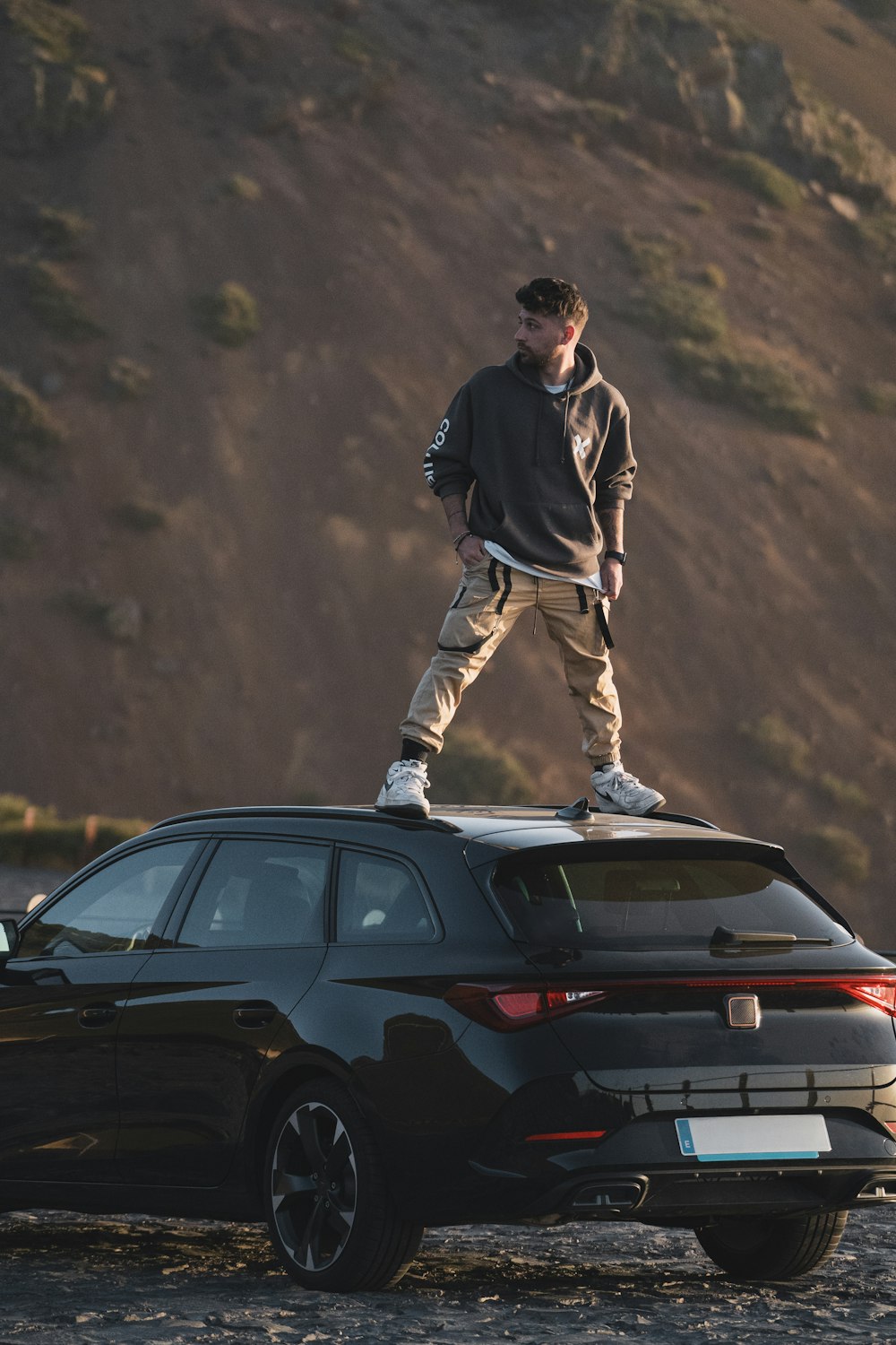 a man standing on top of a car