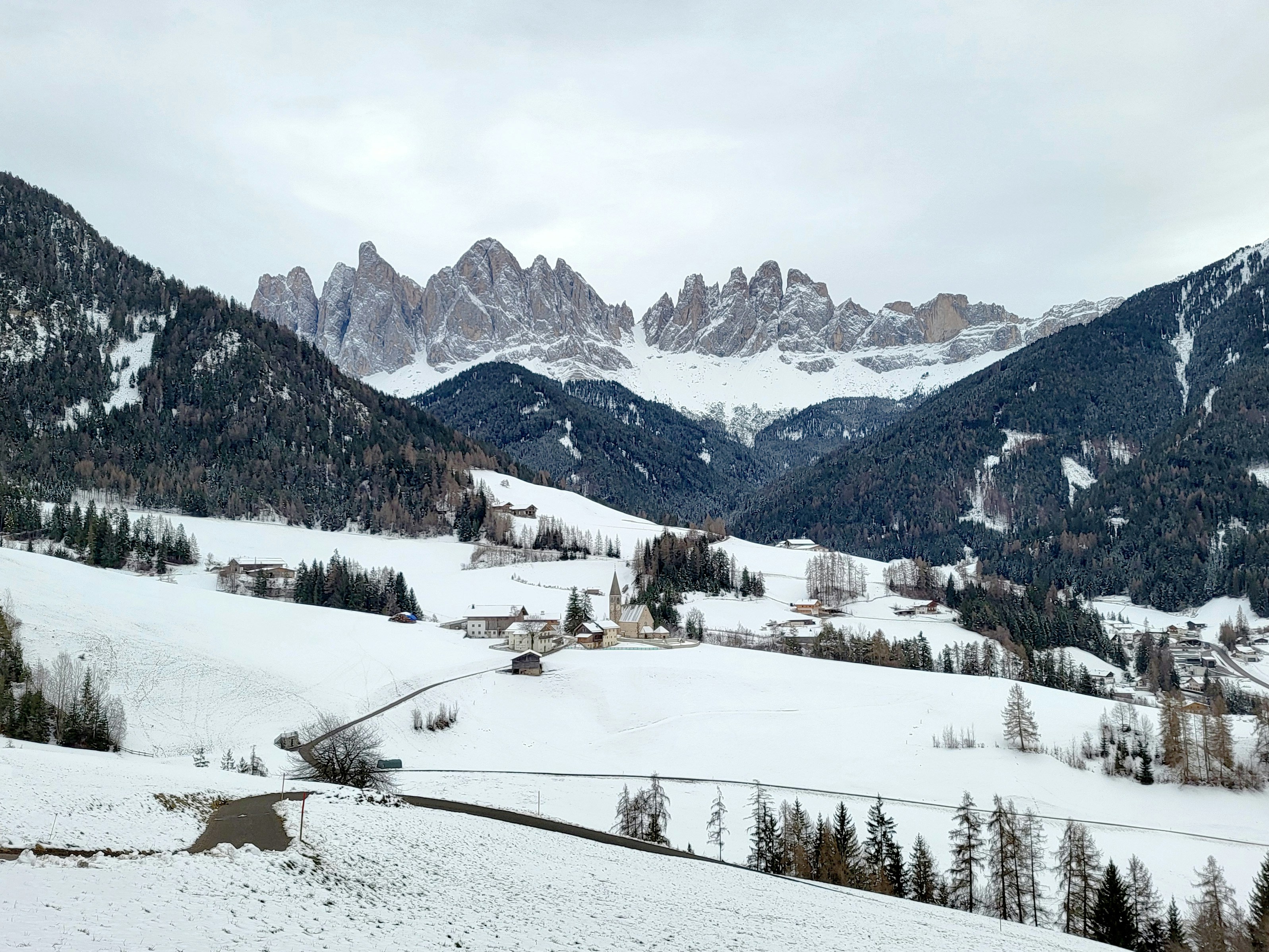 a snowy landscape with mountains in the background