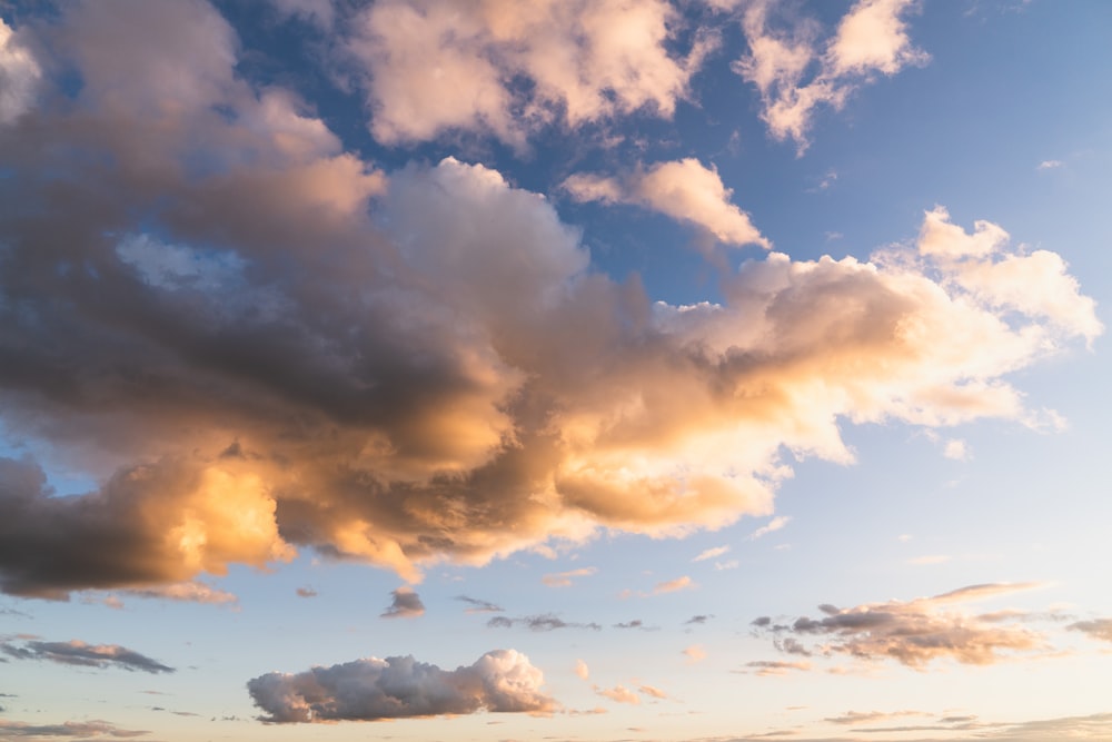 a large cloud is in the sky above a field