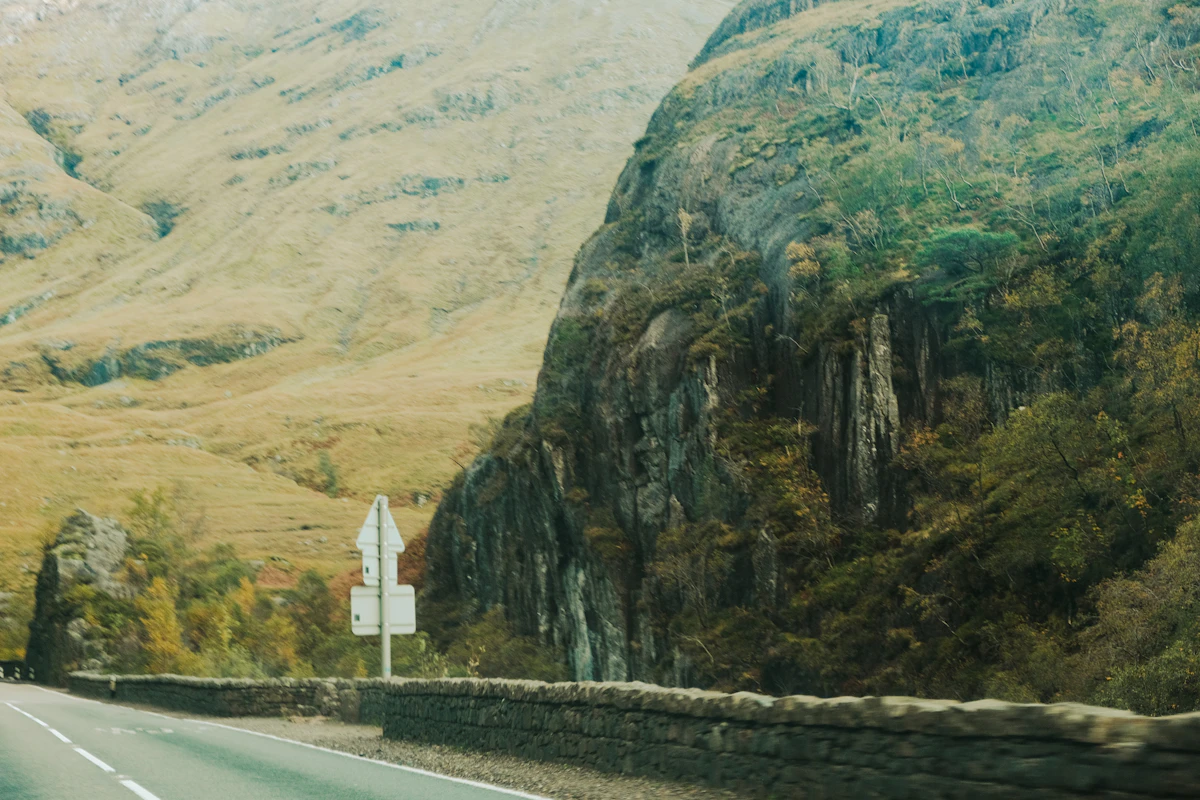 A car winding along a high mountain road