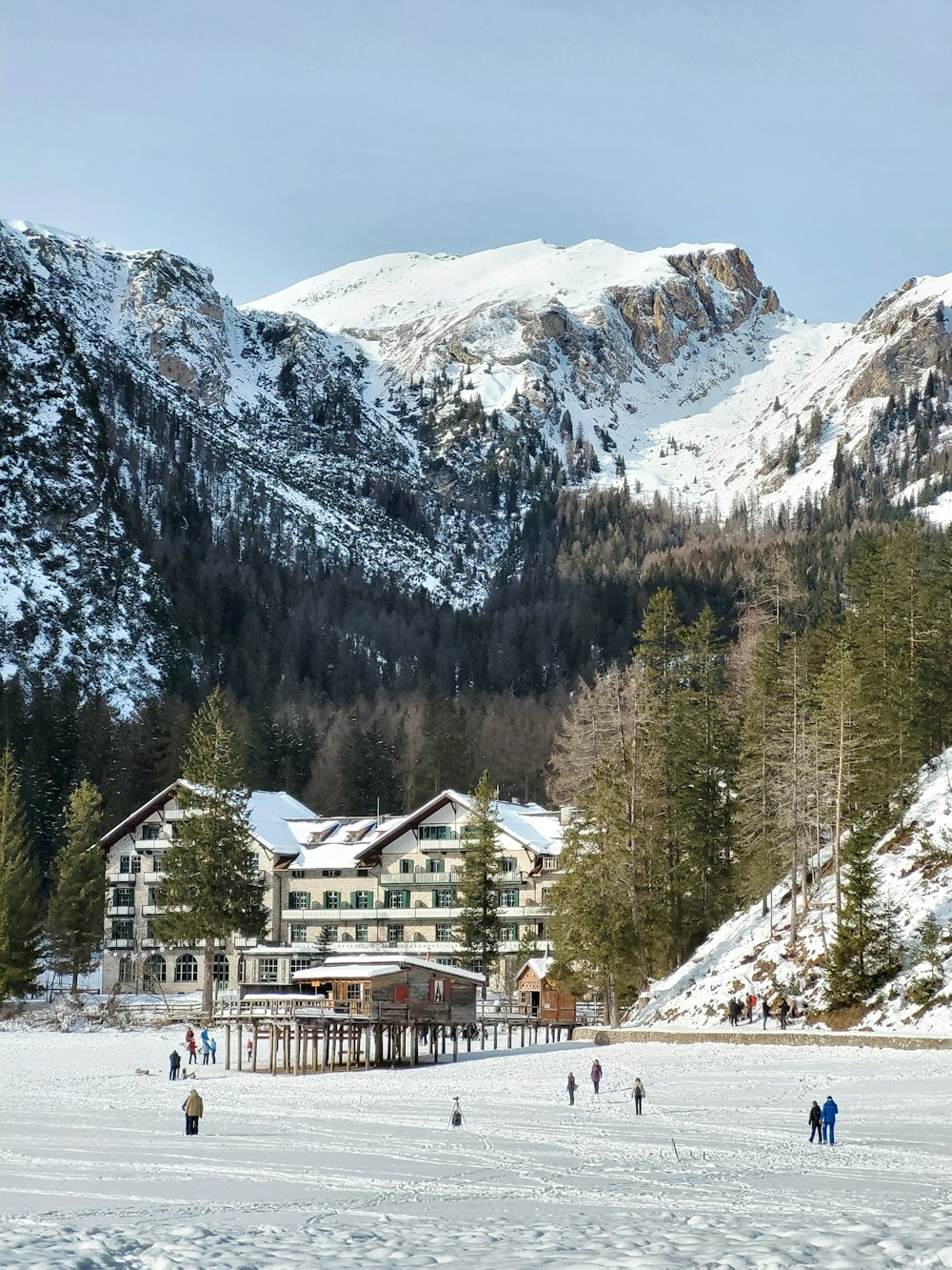 a group of people walking across a snow covered field