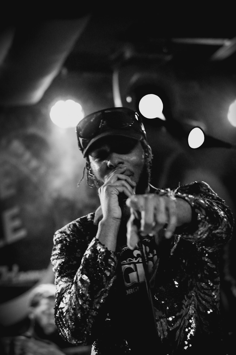 a man holding a microphone while standing in front of a microphone