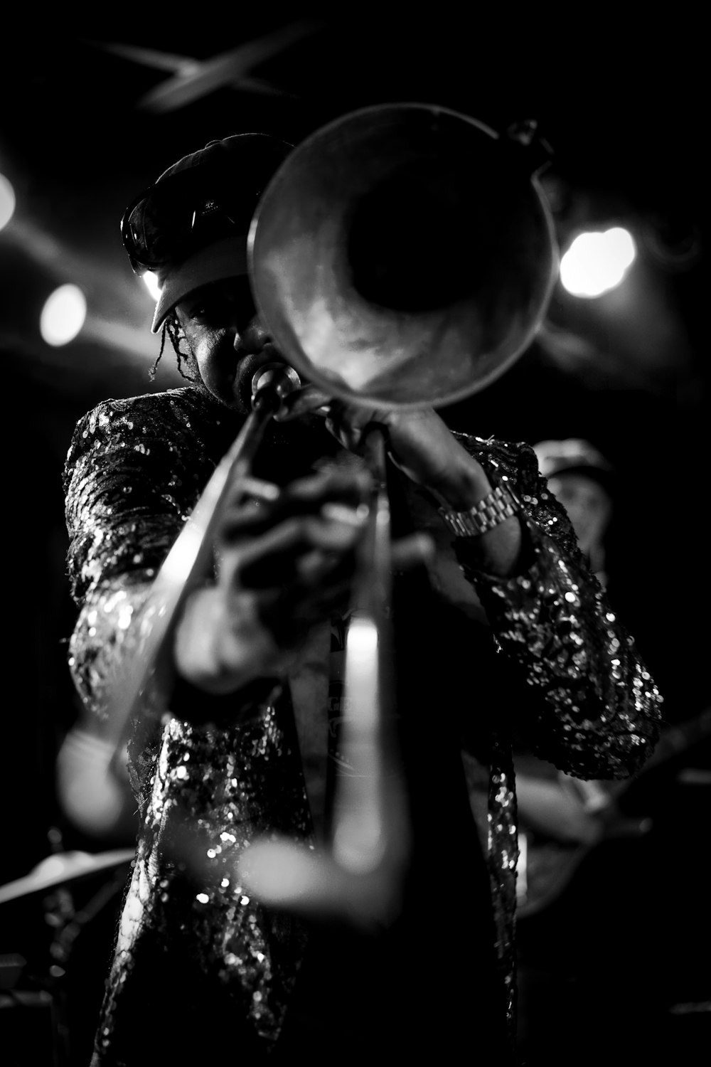 a man playing a trumpet in a black and white photo