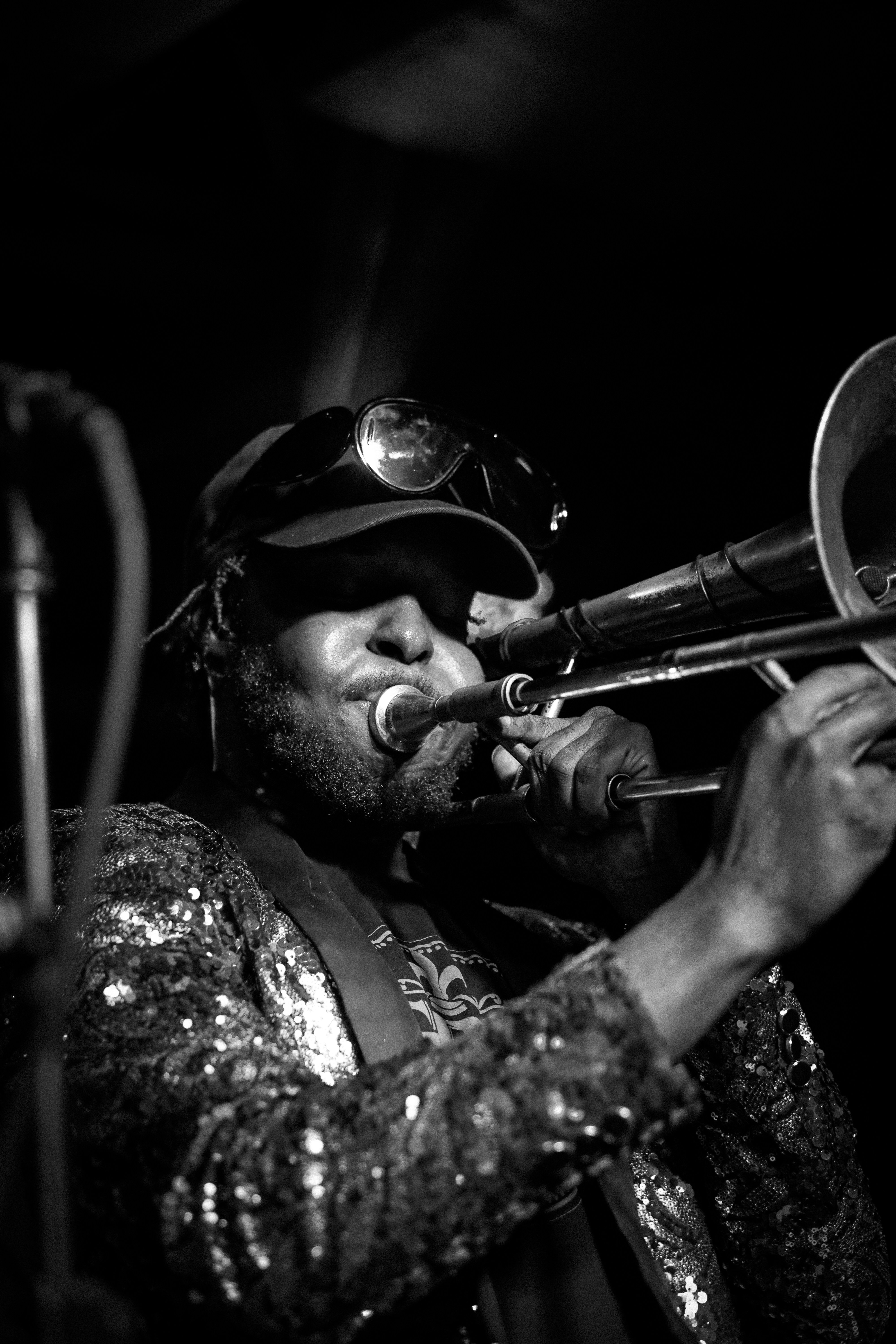 a man playing a trumpet in a black and white photo