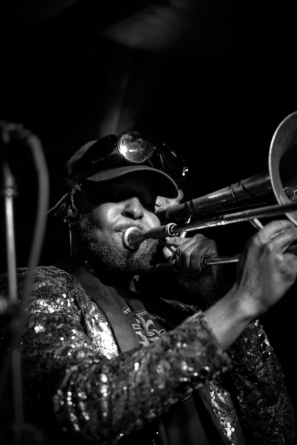 a man playing a trumpet in a black and white photo