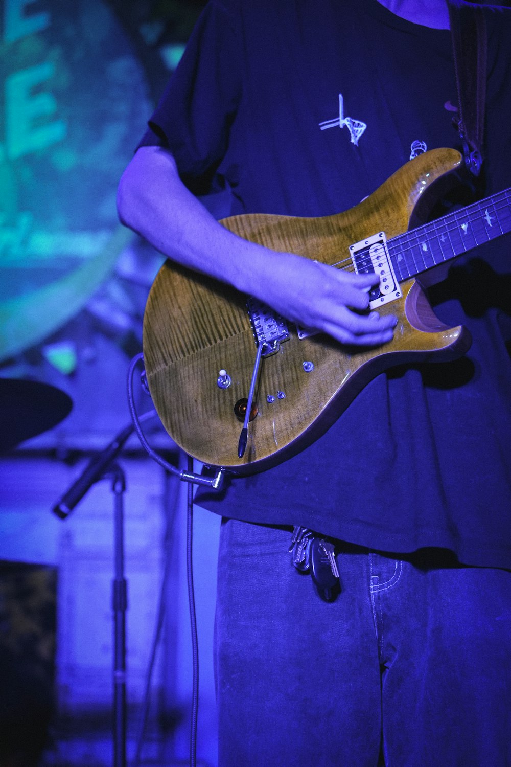 a man is playing a guitar on stage