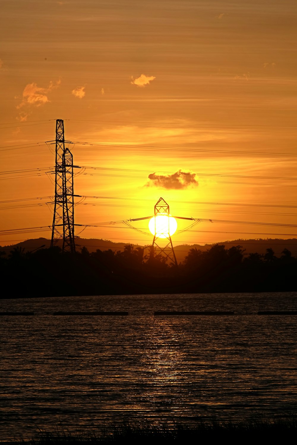 the sun is setting over a body of water