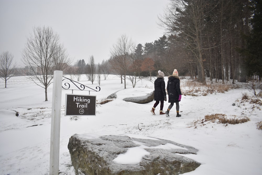 a couple of people that are walking in the snow