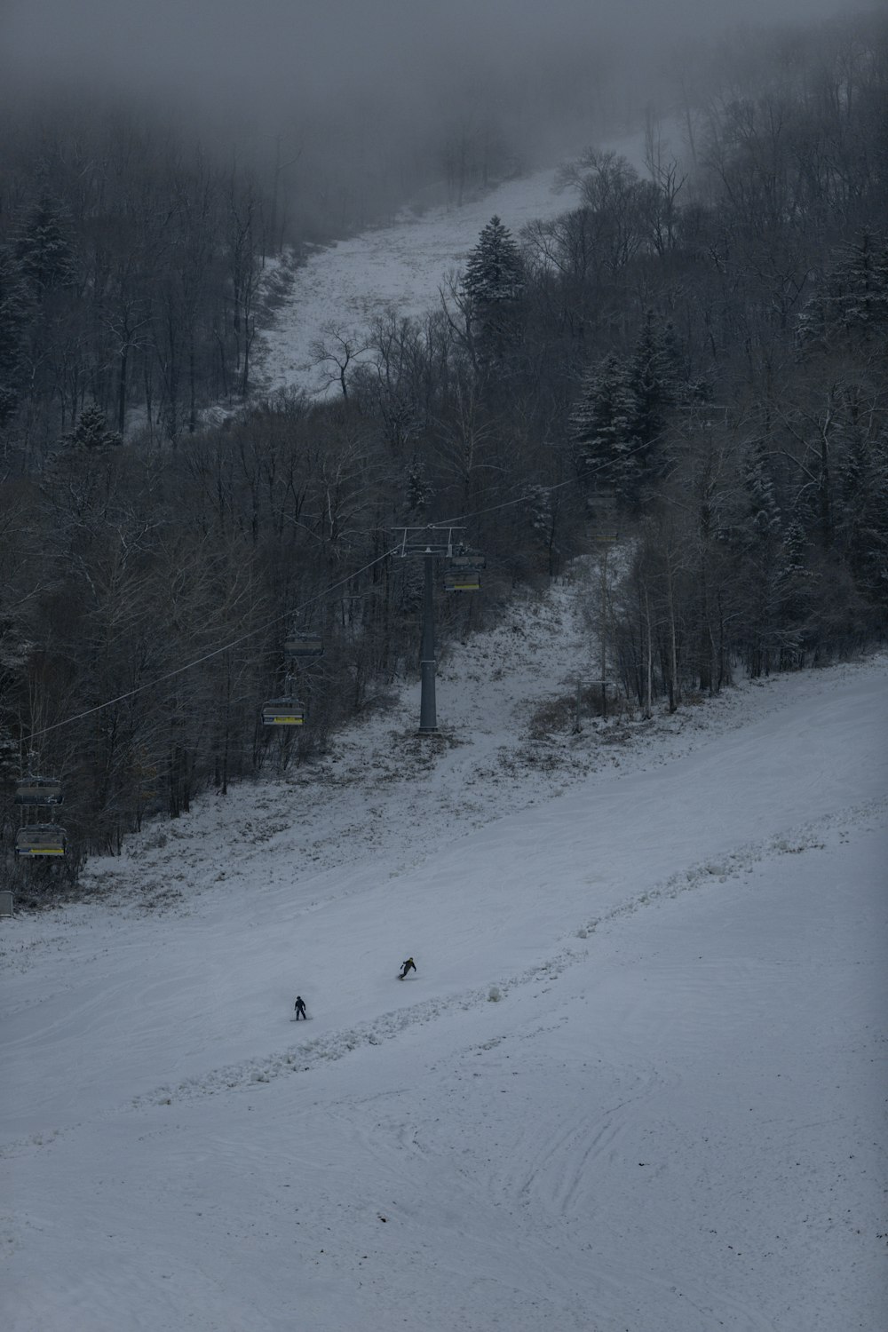 a person riding a snowboard down a snow covered slope