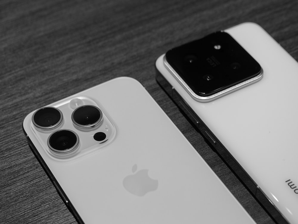 two iphones sitting next to each other on a table